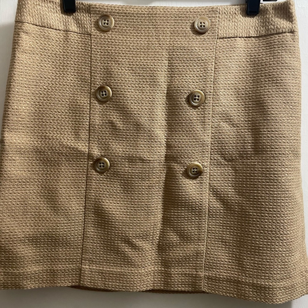 Tan mini skirt.